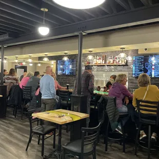 people sitting at tables in a restaurant