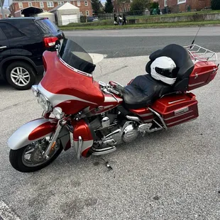 a red motorcycle parked in a parking lot
