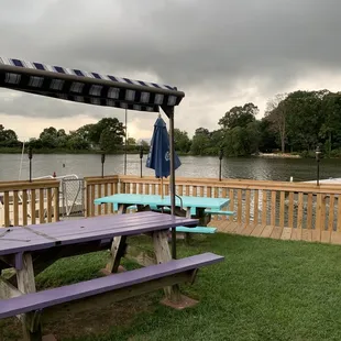 picnic tables and umbrellas on a dock