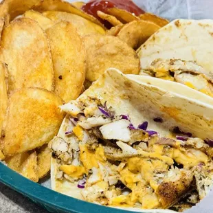 Fish Tacos. Yummy spicy! With house chips.