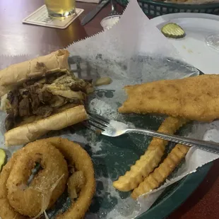 1/2 of philly steak and one of 2 Fish pieces from fish and chips