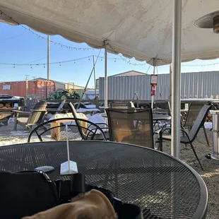 tables and chairs under a tent