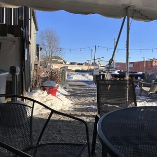a patio area with tables and chairs