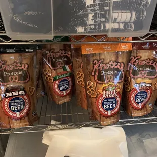 a shelf of beer and pretzels