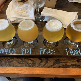 five glasses of beer on a tray