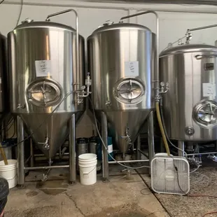 a row of stainless steel tanks