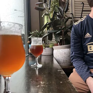 a man sitting in front of a beer glass