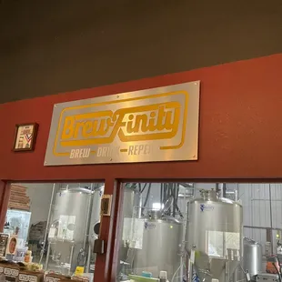 Sign and brew room behind, next to taproom.