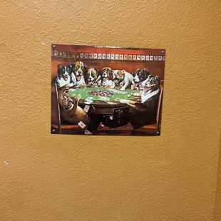 Dogs playing poker in men&apos;s bathroom.  Very funny &amp; quaint.