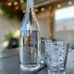 a glass of water and a bottle of water