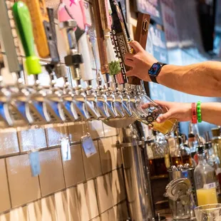 a man filling a beer at a bar