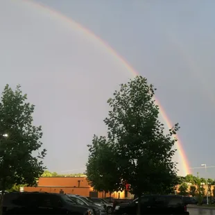 a double rainbow over a parking lot