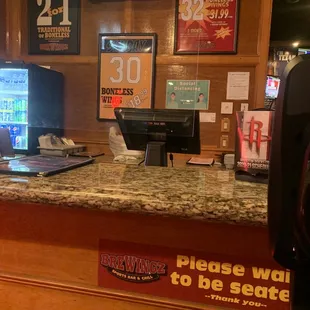 a bar counter with a laptop on it