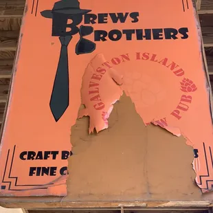 a broken sign hanging from the ceiling