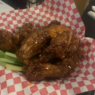 a basket of wings and celery