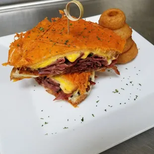 Grilled cheese special: American, pepper jack, provolone, Swiss,  pastrami, Apple wood smoked bacon and a cheddar crust w/onion rings