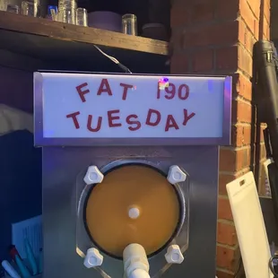 a sign that reads fat 150 tuesday
