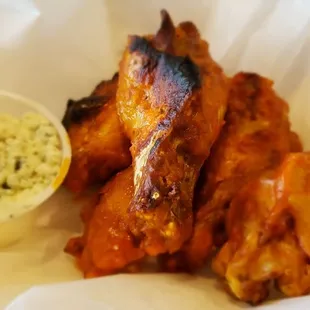 chicken wings and a side of coleslaw