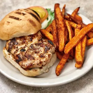 Chicken sandwich on sourdough bun with sweet potato fries