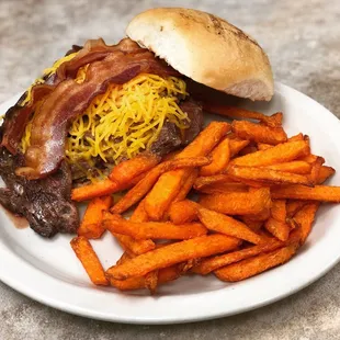Steak sandwich with cheese and bacon. Served with sweet potato fries