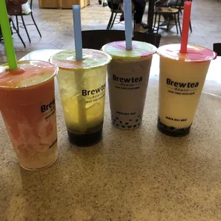 Tiger&apos;s blood smoothie with lychee, lychee fruit green tea with boba, taro milk tea with boba, and coconut pineapple smoothie with boba.