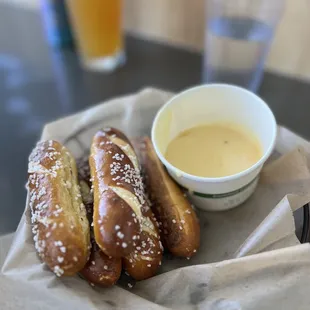 a basket of pretzels and a cup of beer