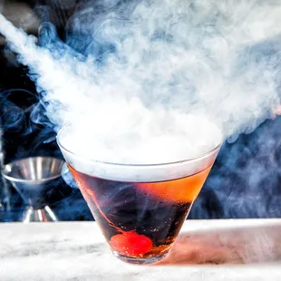 smoke coming out of a cocktail glass