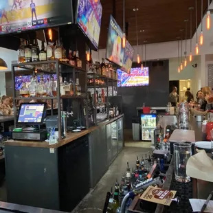 a view of the bar and televisions
