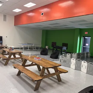 a row of picnic tables in a cafeteria