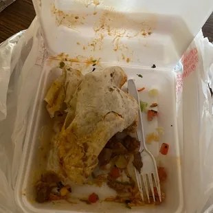 a burrito in a styrofoam container