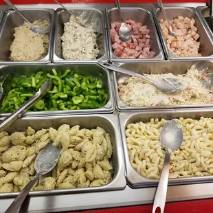 From bottom left to right: Pasta, Macaroni Salad, Celery, Crab Salad, Tuna Salad, Chicken Salad, Diced Ham, Diced Turkey.