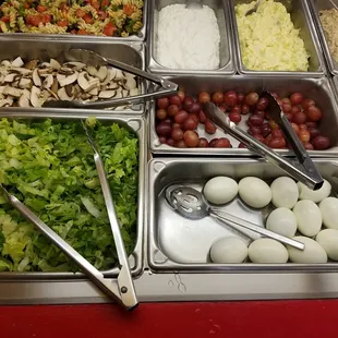 From bottom left to right: Romain Lettuce, Boiled eggs, Mushrooms, Red grapes, Pasta salad, Cottage Cheese, Potato Salad.