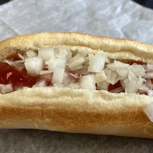 a hot dog with onions and ketchup