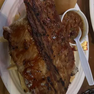 Whole slab of pork back ribs, fries, beans and a roll with butter