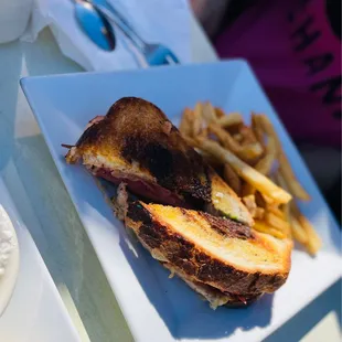 a grilled sandwich and french fries