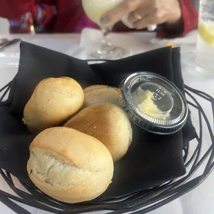 Bread and butter in a plastic ramekin