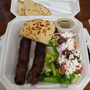 Beef kabobs with salad and pita