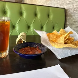 a drink and chips on a table