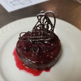a chocolate dessert with a red sauce