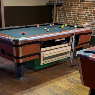 a man playing pool in a bar
