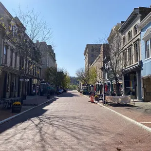 a brick street lined with tables and chairs