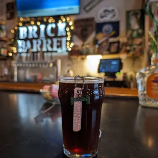 a glass of beer on a bar