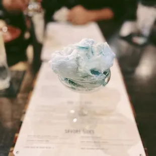 a glass of cotton candy on a table