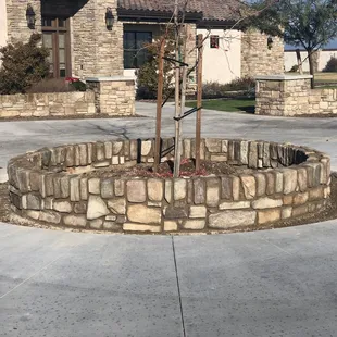 Circle planter seat wall with custom cut concrete flower bed.