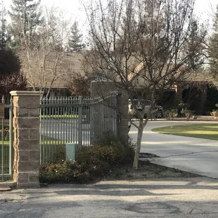Columns with wrought iron gate and fencing