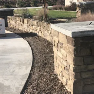 Custom curved block wall with stone finish.