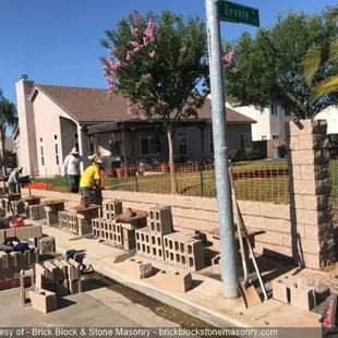 Block Wall Progress Photo: split face tan fence block with columns