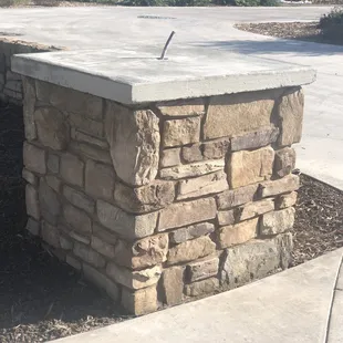 Oversized column with stone veneer and custom concrete cap