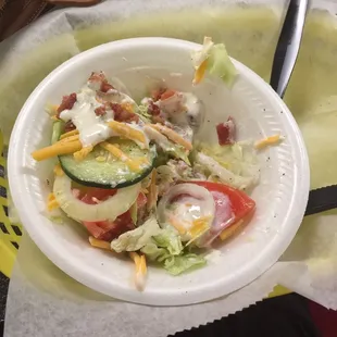 a salad in a paper plate