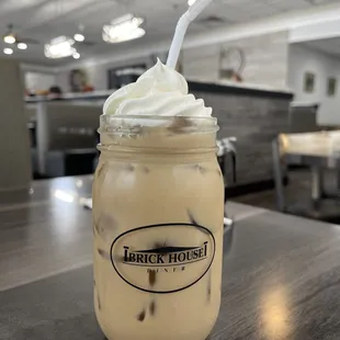 a jar of iced coffee with whipped cream